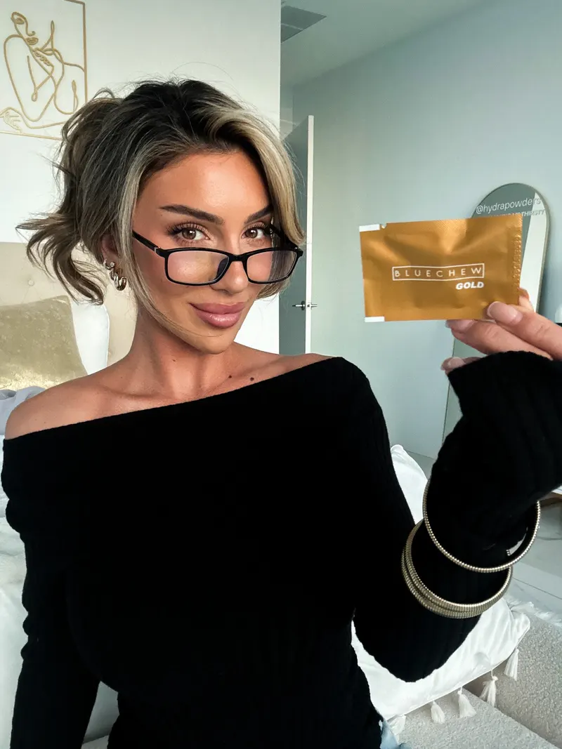 woman lauren blake wearing nerdy glasses with bluechew gold packet