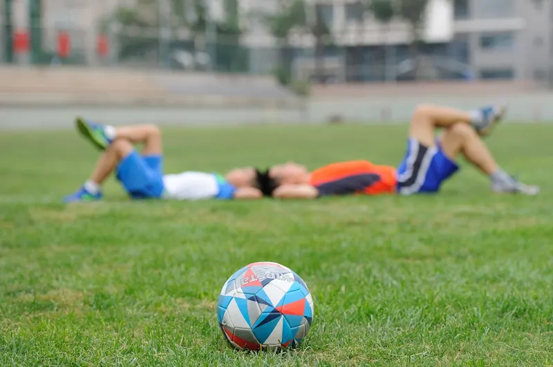 soccer players on green field with ball