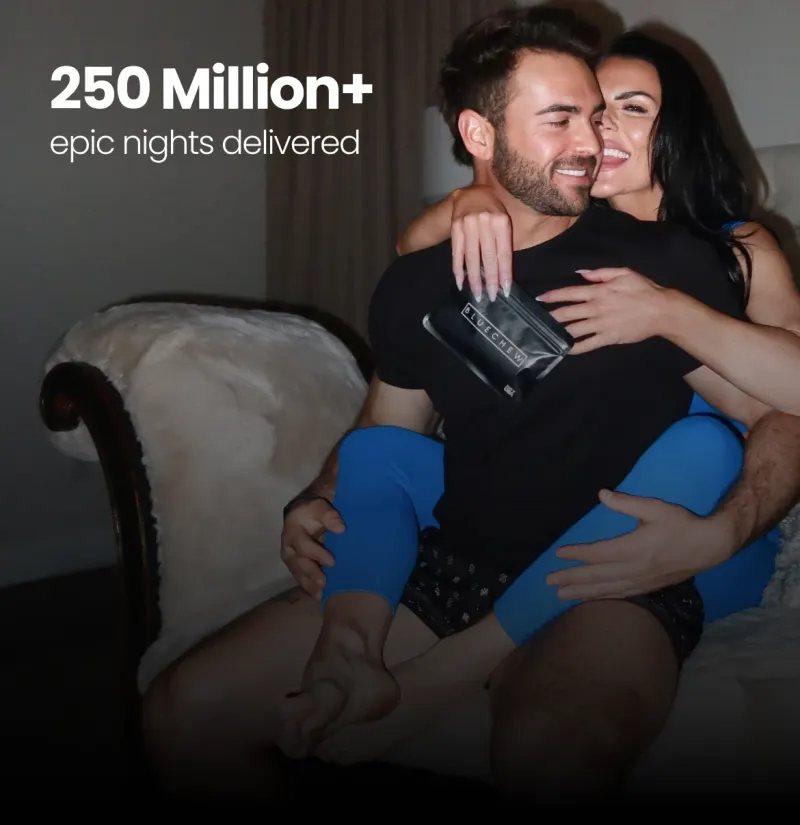 Close-up of smiling couple embracing on a chair, man holding a black BlueChew case, "250 Million+ epic nights delivered"