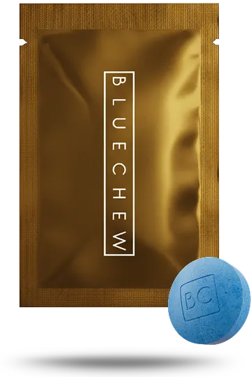 Gold BlueChew packet with a single blue chewable tablet resting beside it