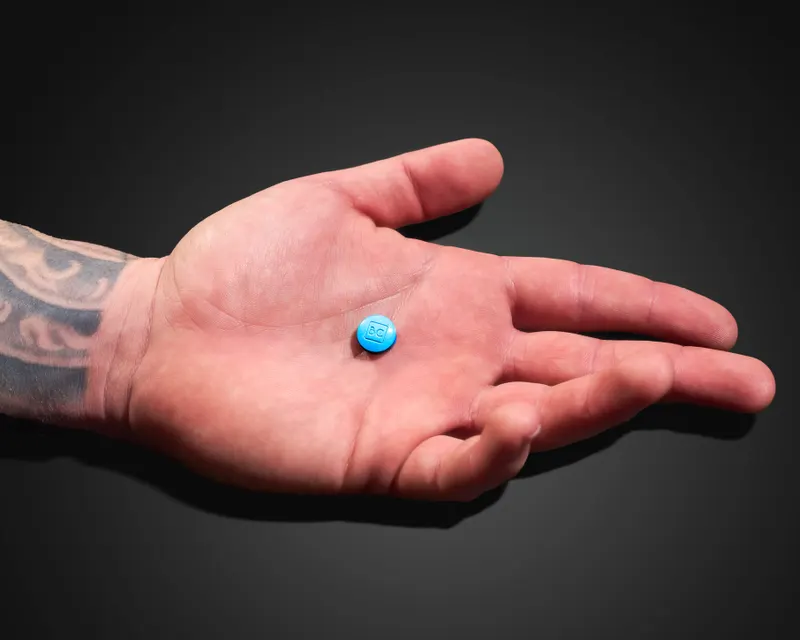 Open hand extended against a dark background, representing ED treatment options