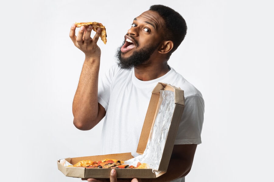 a man eating a slice of pizza
