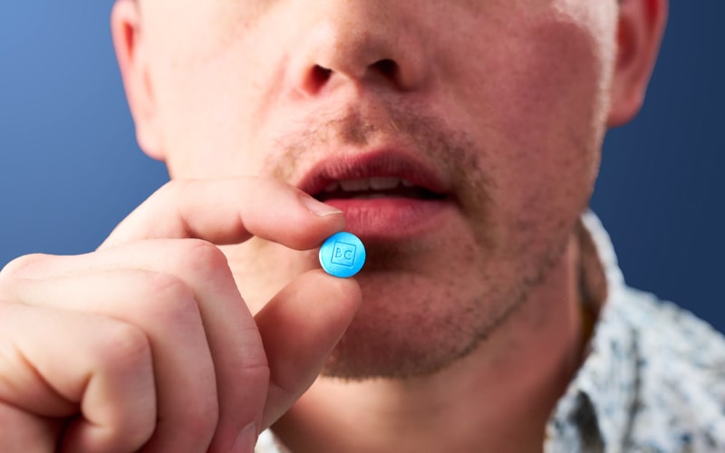 man holding a pill