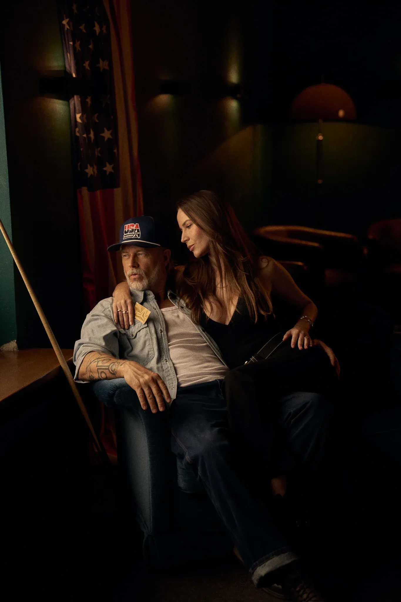 woman sitting on mans lap holding bluechew gold