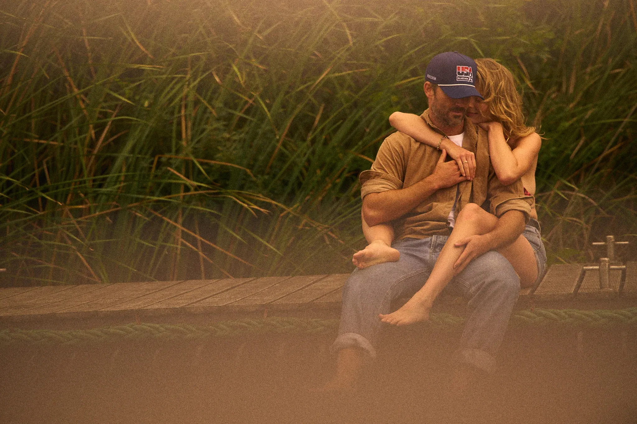 couple sitting outside in grass bluechew gold