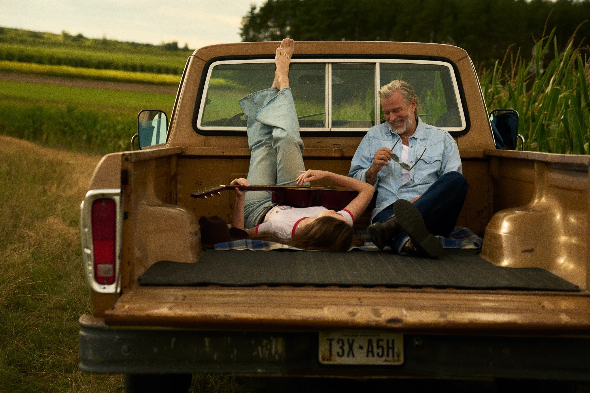 happy couple back of pickup truck bluechew gold